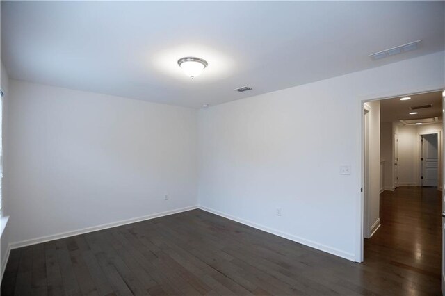 empty room with dark wood-type flooring