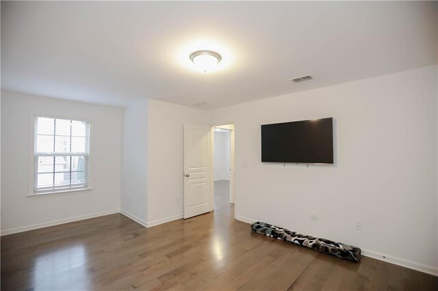 spare room with hardwood / wood-style flooring