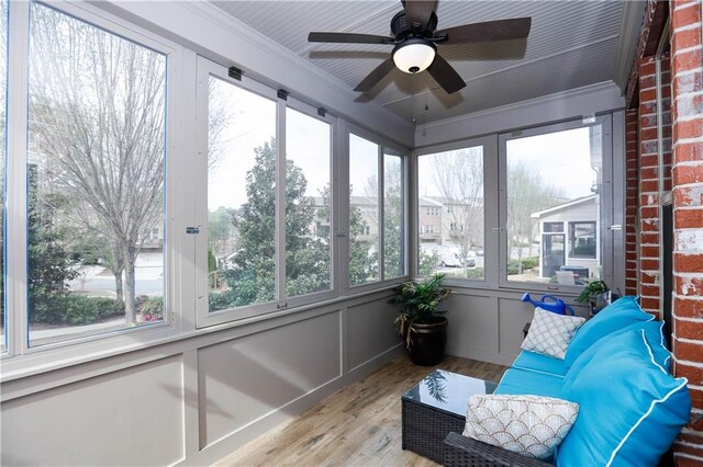 sunroom with ceiling fan and a healthy amount of sunlight