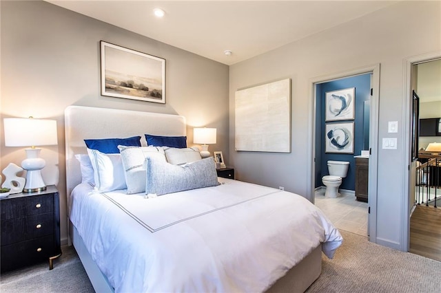 carpeted bedroom with recessed lighting, baseboards, and ensuite bathroom