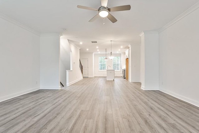 unfurnished living room with crown molding, light hardwood / wood-style flooring, and ceiling fan