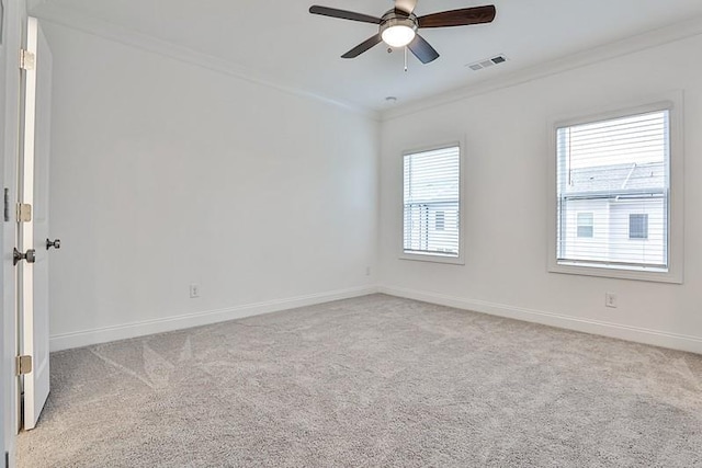 unfurnished room featuring ornamental molding, light colored carpet, and ceiling fan