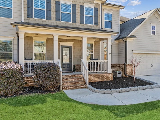 entrance to property with a garage and a porch