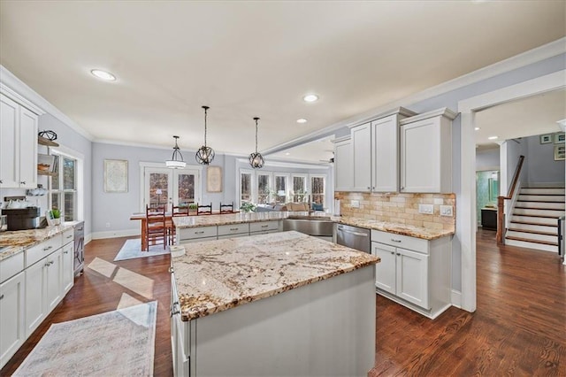 kitchen featuring white cabinetry, french doors, hanging light fixtures, kitchen peninsula, and a kitchen island