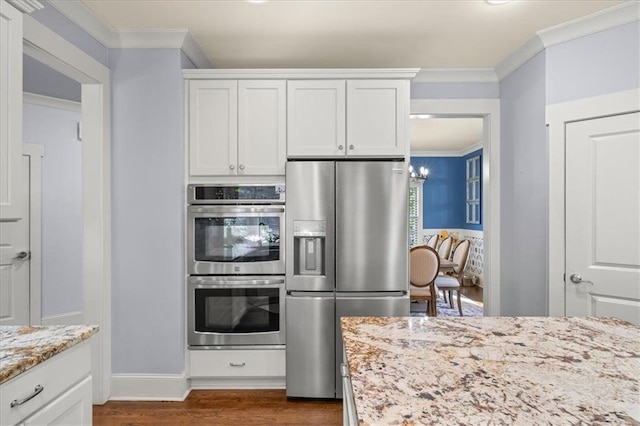 kitchen featuring white cabinetry, stainless steel appliances, light stone counters, dark hardwood / wood-style floors, and ornamental molding