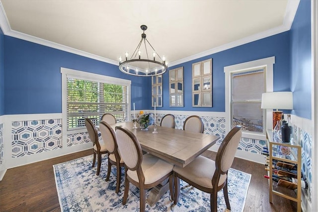 dining room featuring dark hardwood / wood-style floors, an inviting chandelier, and ornamental molding