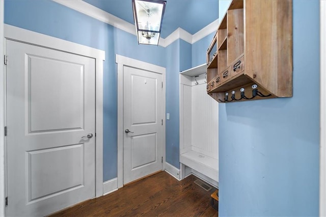 mudroom featuring dark wood-type flooring and ornamental molding