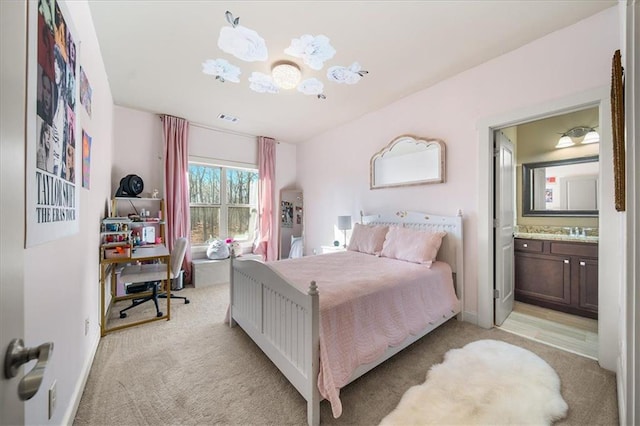 carpeted bedroom with ensuite bath