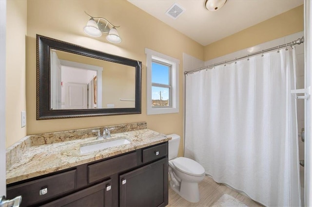 bathroom with hardwood / wood-style flooring, vanity, toilet, and a shower with curtain