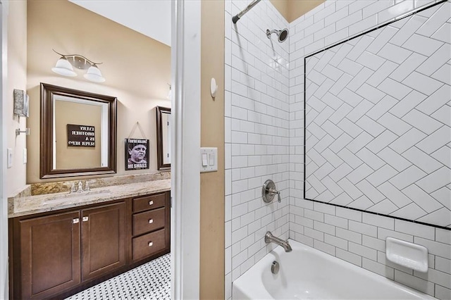 bathroom featuring tiled shower / bath combo and vanity