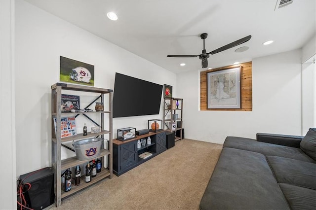 carpeted living room with ceiling fan