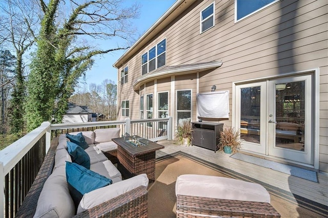 deck featuring outdoor lounge area and french doors