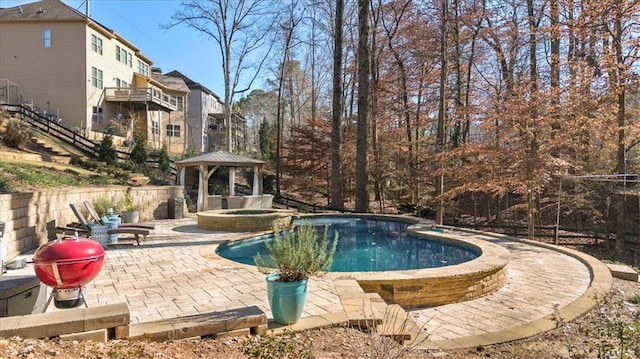 view of swimming pool with a gazebo and a patio