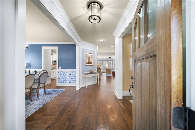 entryway featuring dark hardwood / wood-style floors and crown molding