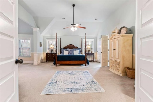 bedroom with lofted ceiling, multiple windows, visible vents, and light colored carpet