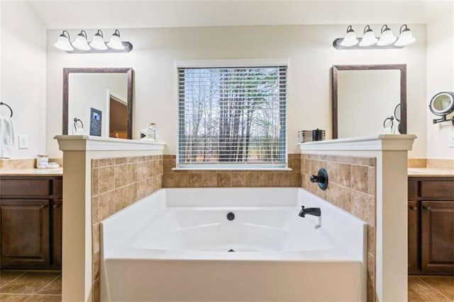 full bath with a garden tub, vanity, and tile patterned floors