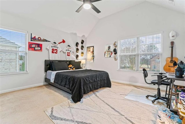 bedroom with light carpet, vaulted ceiling, baseboards, and multiple windows