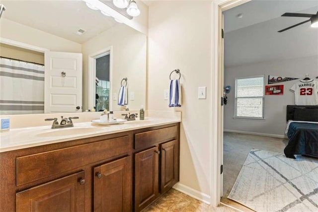 bathroom featuring a sink, double vanity, a ceiling fan, and connected bathroom