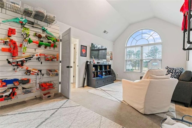 interior space featuring carpet floors, lofted ceiling, and visible vents