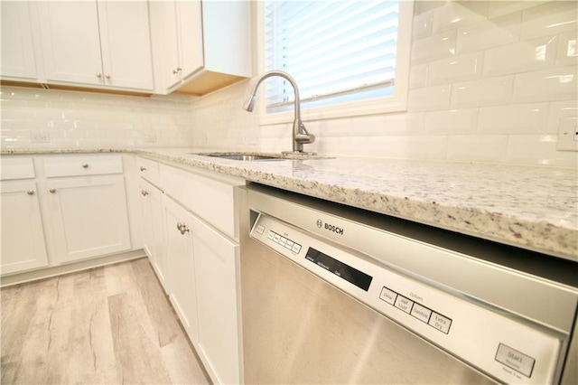 243 Hummingbird Trl, Dallas, GA 30132 - kitchen with dishwasher, white cabinetry, backsplash, and light stone countertops