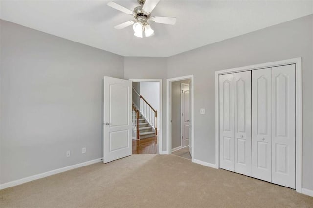 unfurnished bedroom featuring a closet, carpet flooring, and baseboards