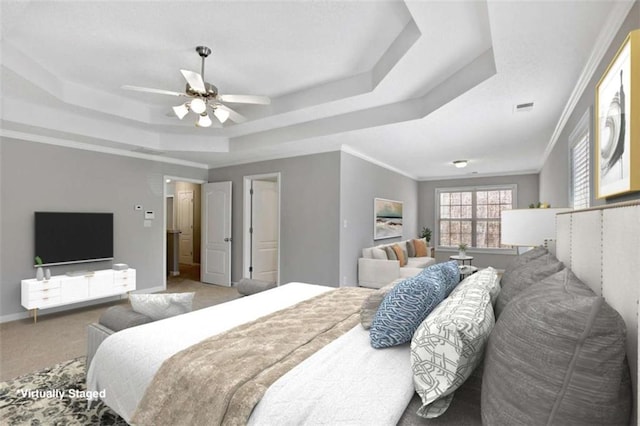 carpeted bedroom with a tray ceiling, visible vents, crown molding, and baseboards