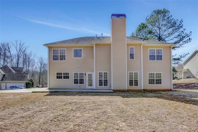 back of house with a patio area and a chimney