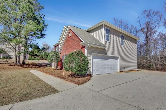 view of home's exterior with a garage, concrete driveway, and brick siding