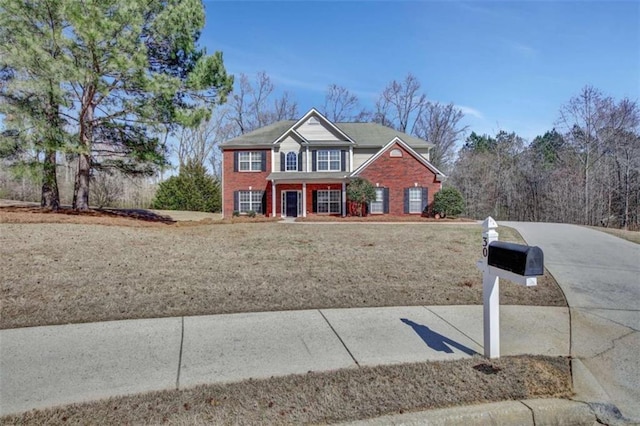 view of front of property with a front lawn and brick siding