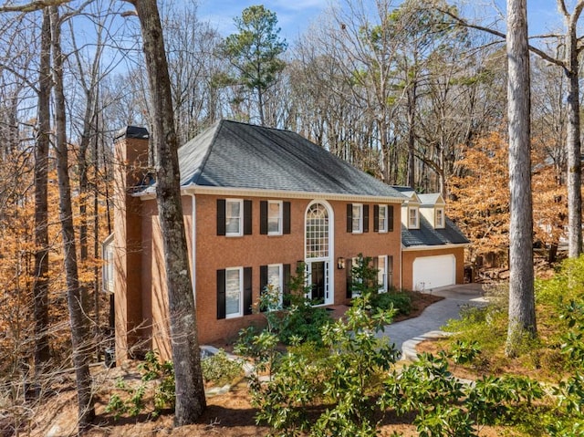 view of front of house with a garage and a chimney