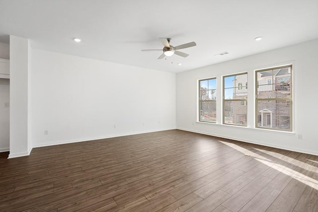 empty room with ceiling fan and dark hardwood / wood-style floors