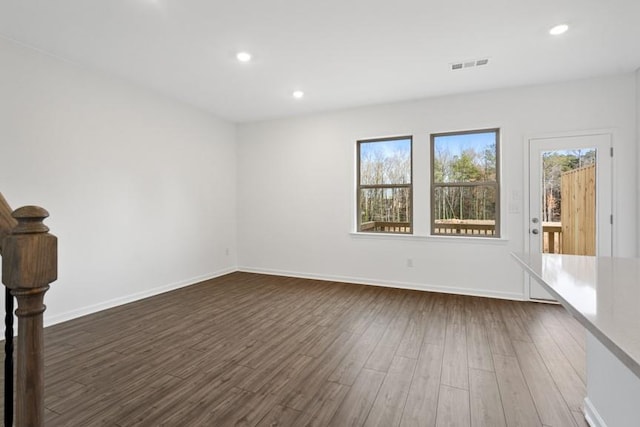 unfurnished room featuring dark wood-type flooring