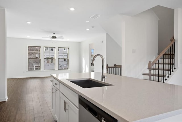 kitchen featuring white cabinets, sink, a kitchen island with sink, ceiling fan, and stainless steel dishwasher