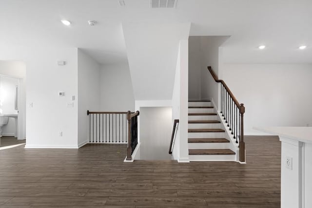 staircase with hardwood / wood-style flooring