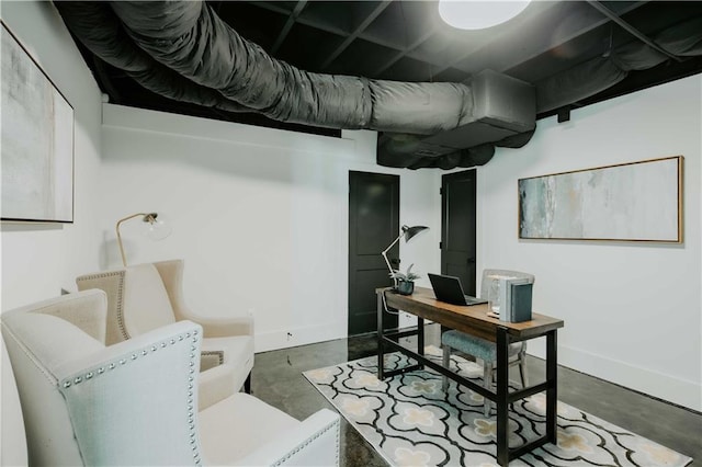 office space featuring concrete floors and baseboards