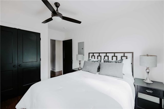 bedroom with ceiling fan and dark wood-style floors