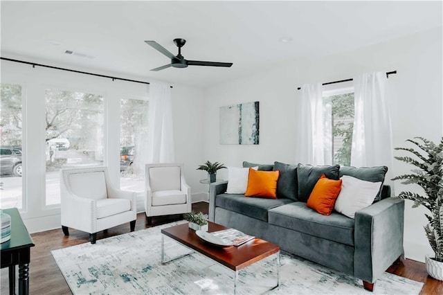living area with ceiling fan and wood finished floors