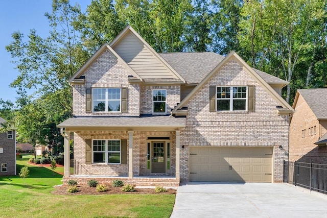 view of front facade featuring a front lawn, a porch, and a garage