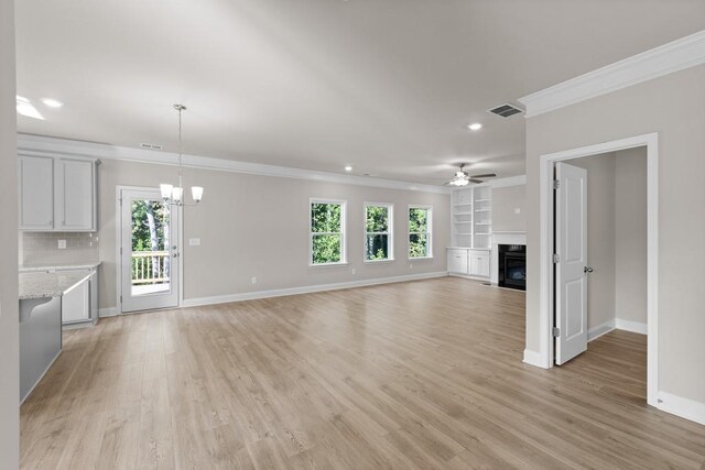 unfurnished dining area with a notable chandelier, light hardwood / wood-style floors, and plenty of natural light