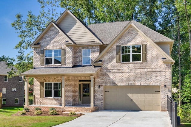 view of front of property with covered porch and a garage