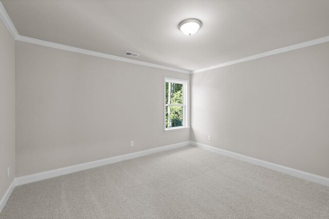 carpeted empty room featuring ornamental molding