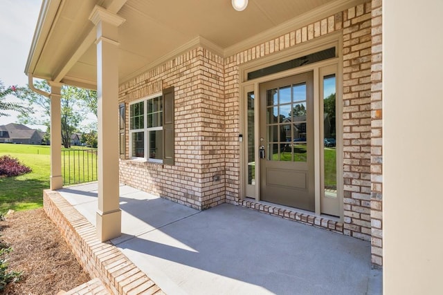 view of exterior entry featuring covered porch