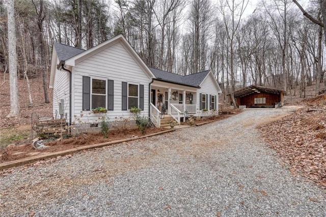 view of front of home featuring a carport and covered porch