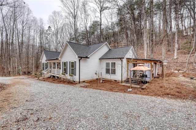 view of side of property with a gazebo and covered porch