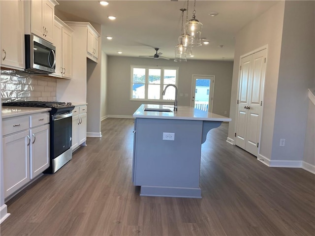 3352 Cranston Ln, Kennesaw, GA 30144 - kitchen featuring appliances with stainless steel finishes, a sink, ceiling fan, an island with sink, and backsplash
