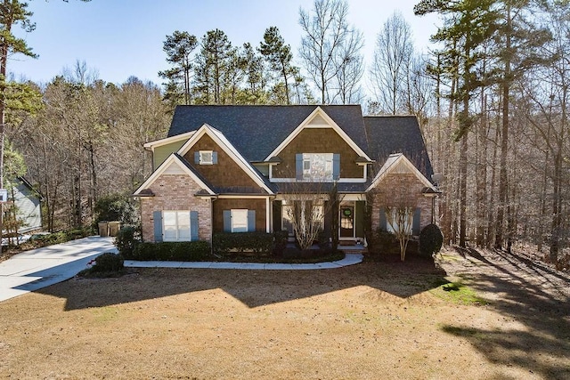 craftsman house featuring brick siding