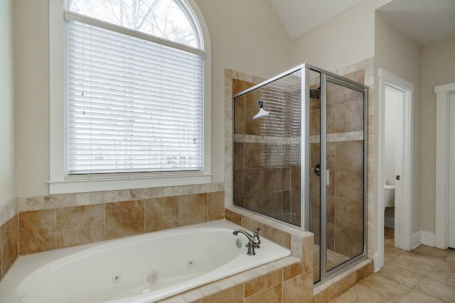 full bath with a jetted tub, a shower stall, toilet, and tile patterned floors