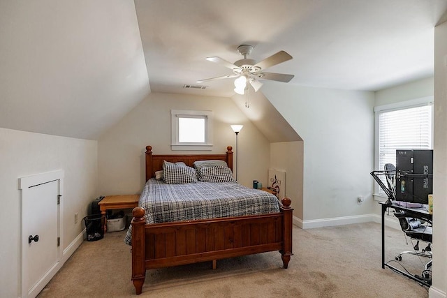 bedroom with light carpet, baseboards, visible vents, a ceiling fan, and lofted ceiling