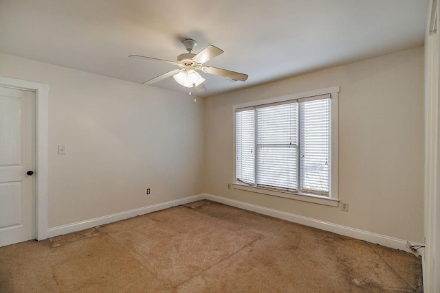 unfurnished room featuring light carpet, ceiling fan, and baseboards