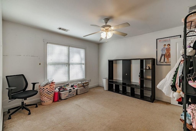 interior space featuring carpet floors, visible vents, baseboards, and a ceiling fan